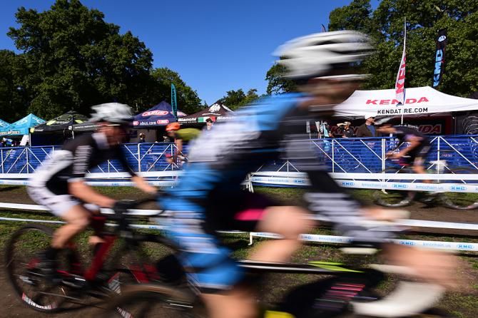 Riders passing by the large Industry Expo