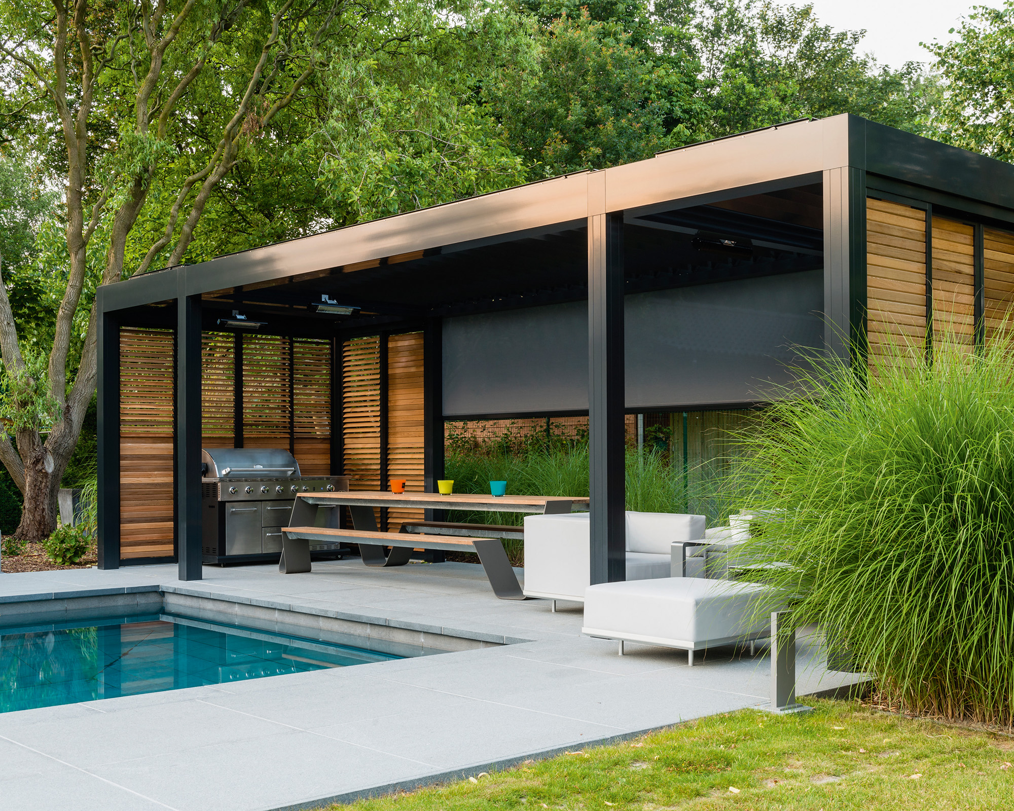 black pool canopy over a white paved seating area