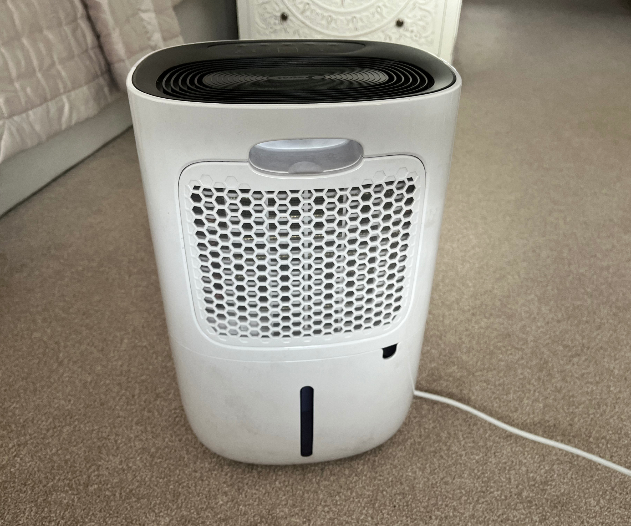 back of white dehumidifier with inbuilt carrying handle, filter and water tank