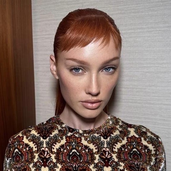 Meredith Duxbury wears her hair in a slick-back style with a micro bang.