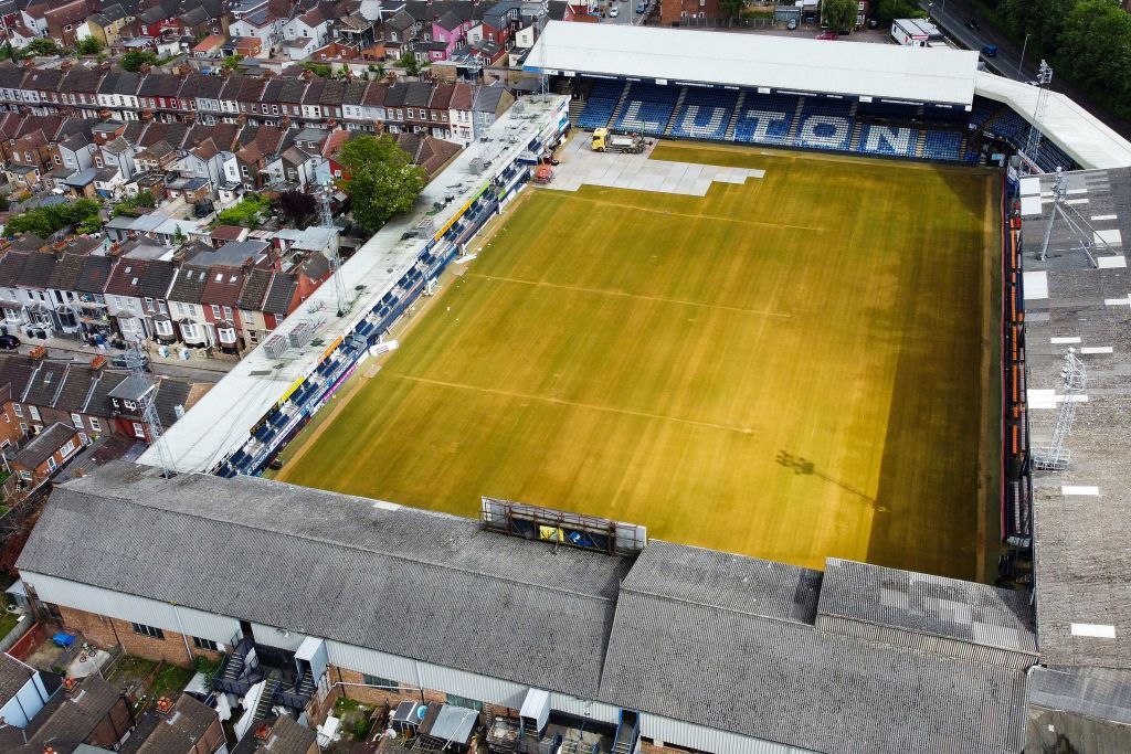 An aerial picture taken on May 31, 2023 shows Luton Town&#039;s Kenilworth Road stadium, in Luton, as members of the ground staff remove the pitch lines and cover the grass during the end of season works. Luton&#039;s football team completed a fairytale journey to the Premier League after beating Coventry on penalties in the Championship playoff final at Wembley last week on May 27, 2023. Financial experts estimate promotion to world football&#039;s most watched league to be worth around £170 million ($210 million) for a club that have been through turmoil since they last played in the top flight 31 years ago. Luton are the first club to go from the fifth tier to the top flight in the Premier League era.