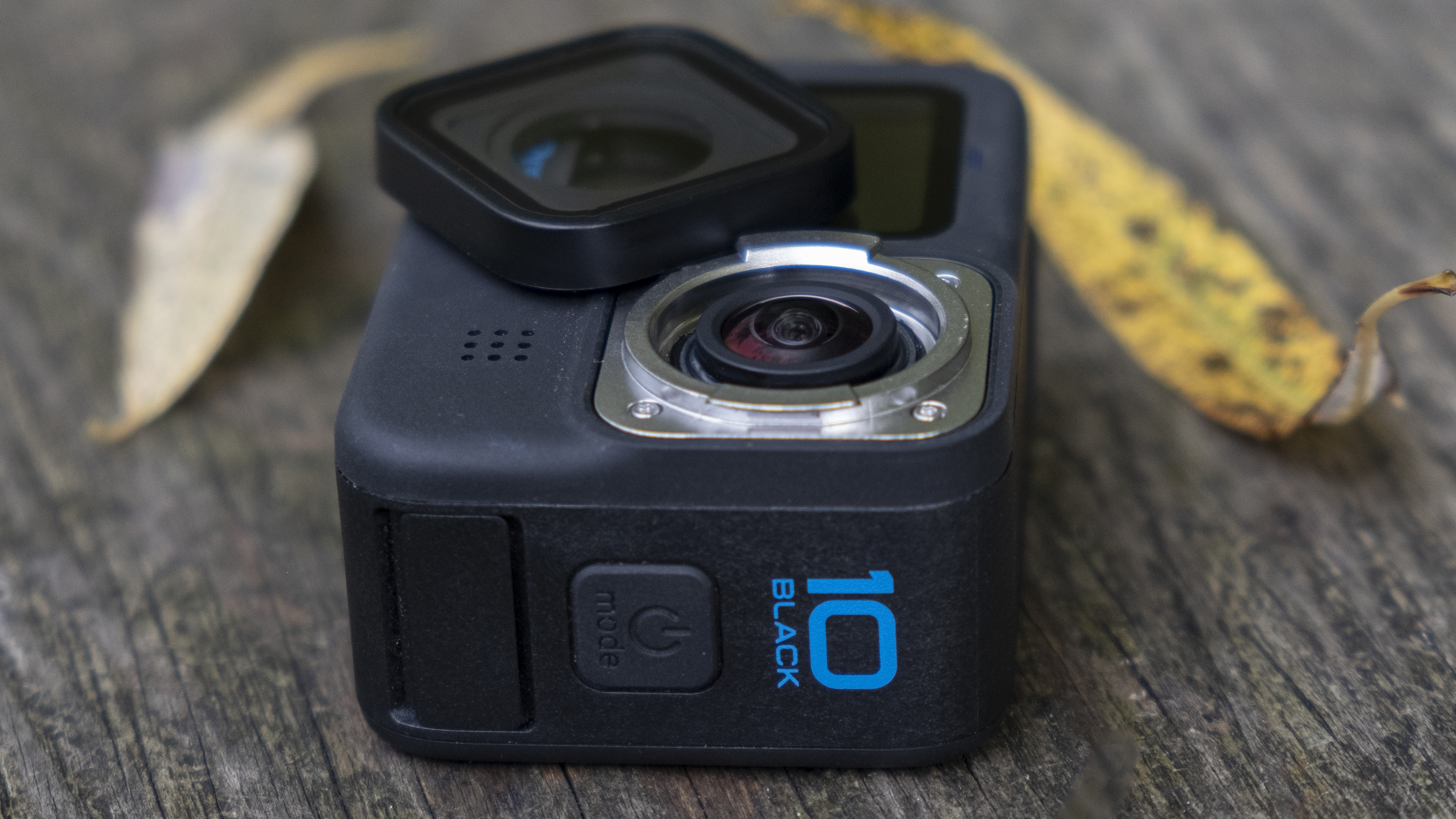 The GoPro Hero 10 Black action camera sitting on a wooden bench