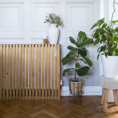 Living room with radiator covered in wooden cover.