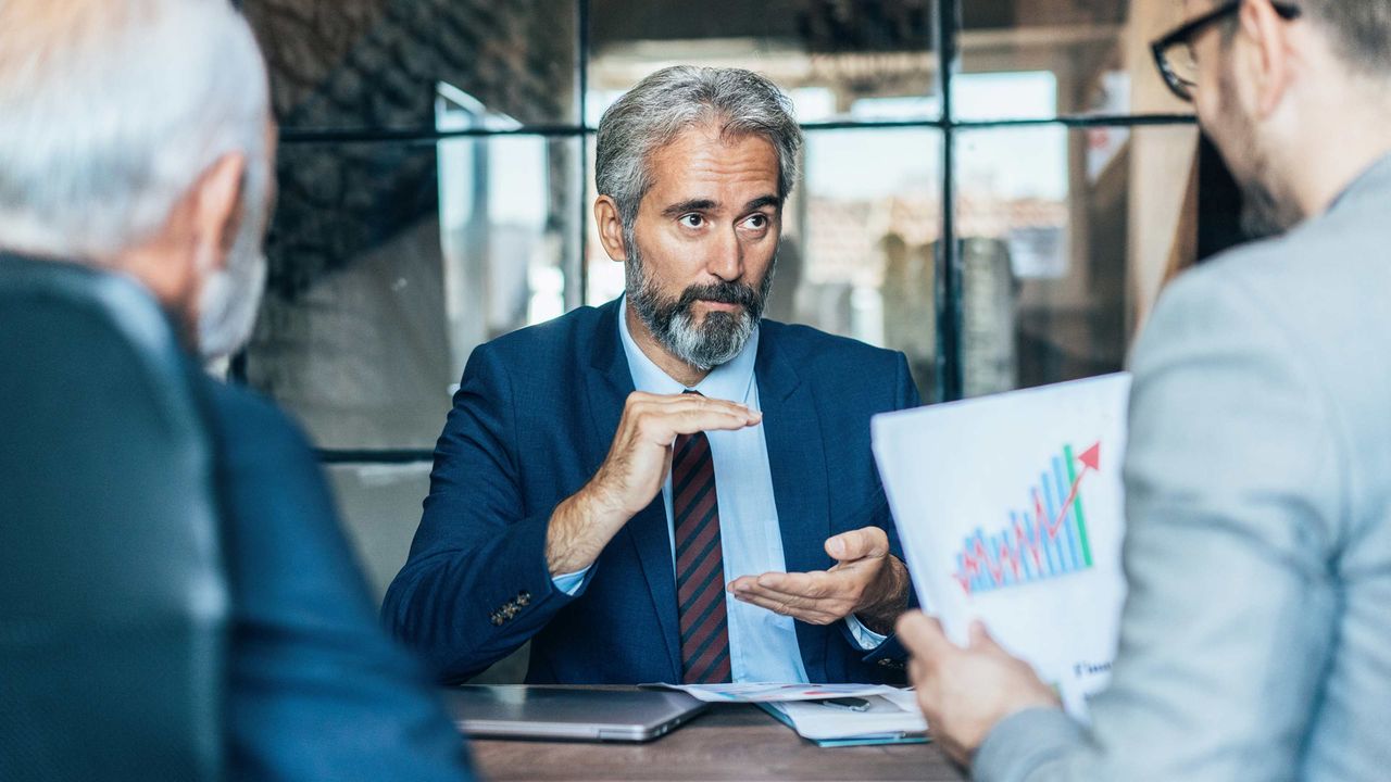 Senior financial adviser working with a couple who are clients