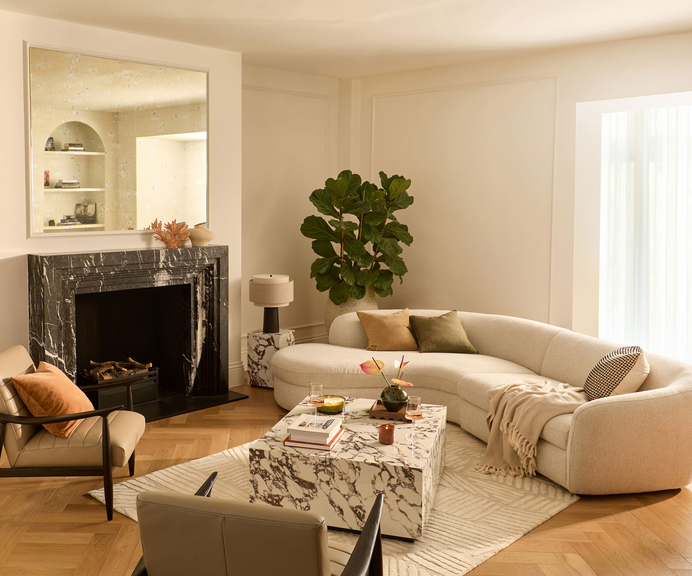 retro living room with curved statement sofa and marble effect coffee table with retro armchairs