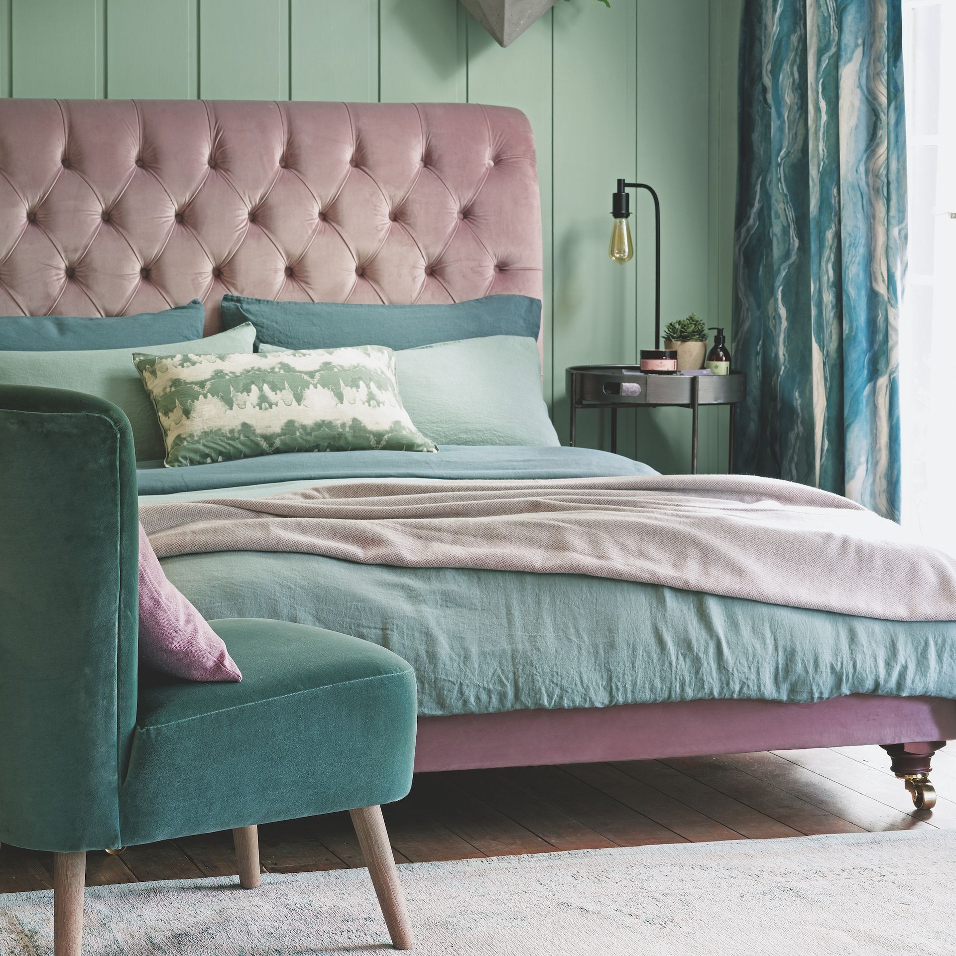 green and pink bedroom with upholstered bed