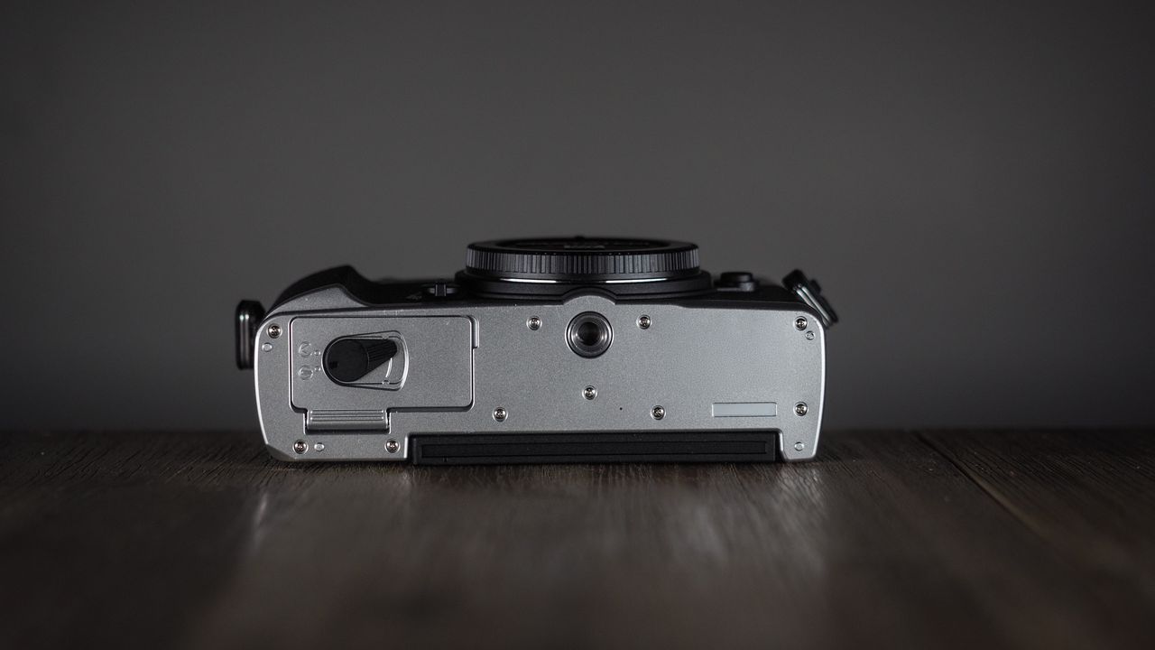 OM System OM-3 on a wooden surface
