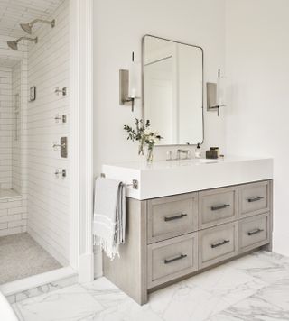 A bathroom with a built in shower bench in the same material as the wall
