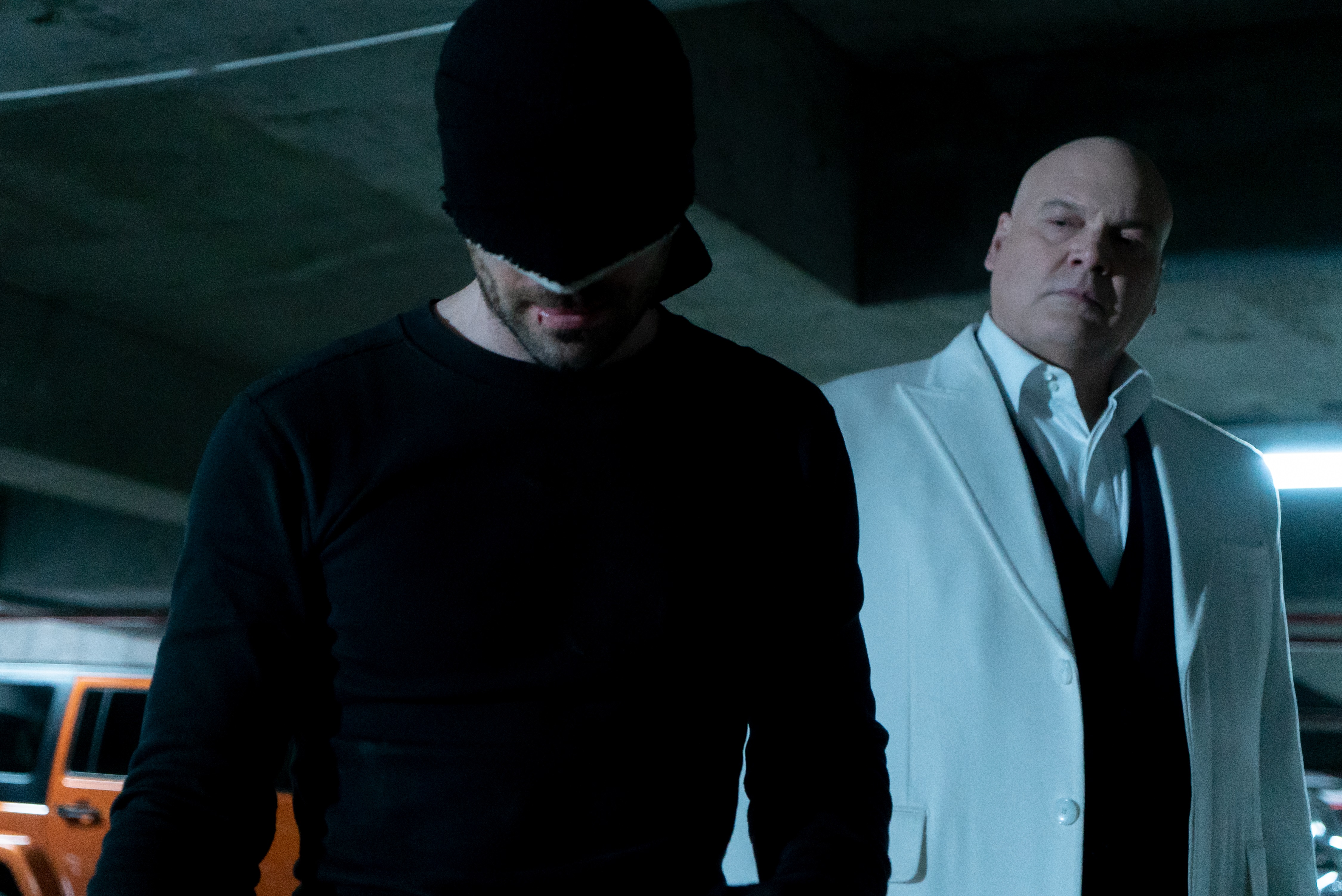 Daredevil in a black suit with kingpin in the background