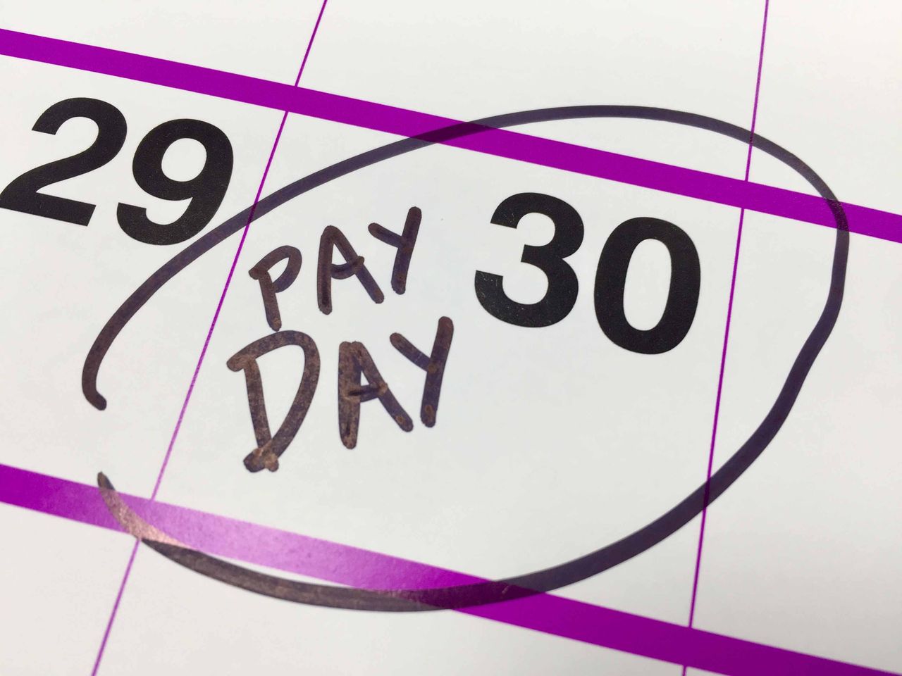 Photo of calendar day with &amp;quot;Payday&amp;quot; written on it