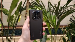 The Redmi Note 14 Pro Plus against a houseplant