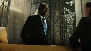 Lance Reddick's Charon standing at Continental concierge desk in John Wick spinoff Ballerina