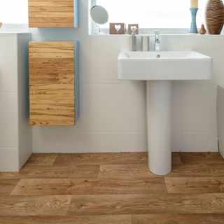 bathroom with wash basin and wooden flooring