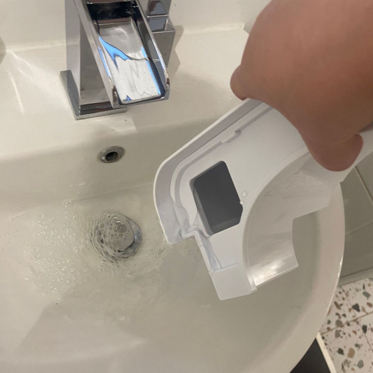 Challenge D015B 12L Dehumidifier water tank being emptied down a sink