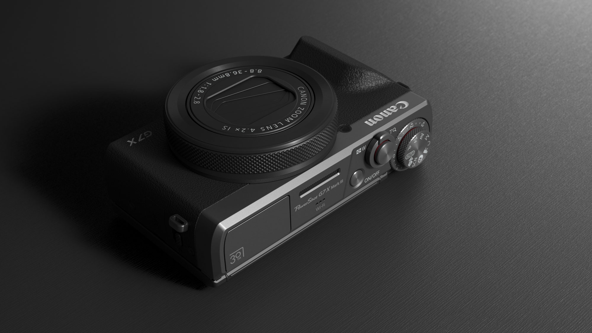 Canon PowerShot G7 X Mark III Anniversary Edition in graphite, laying flat on a graphite-type surface