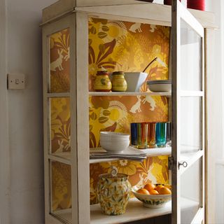 cupboard with glass door and crockery