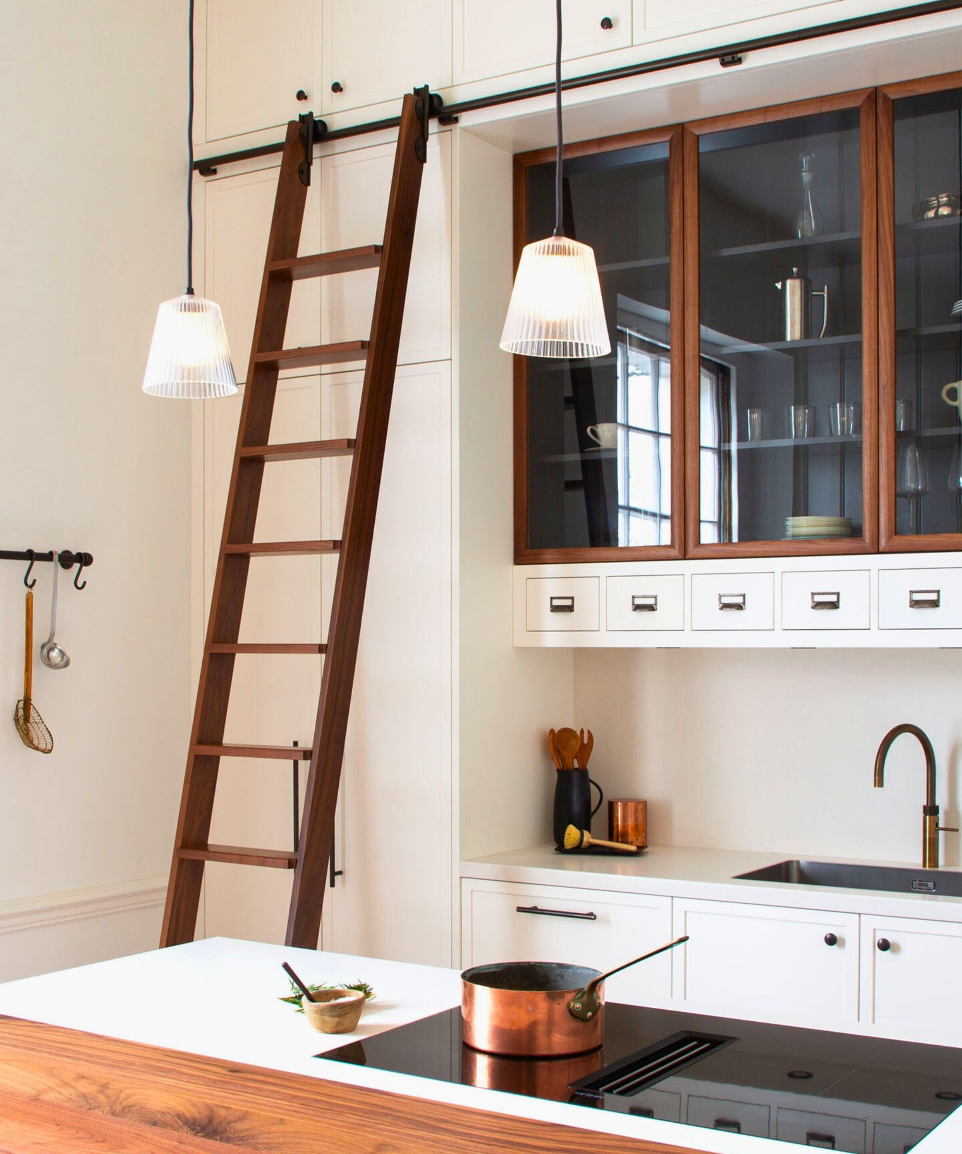 A wooden kitchen ladder in a white kitchen
