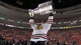 Jonathan Toews holding the Stanley Cup
