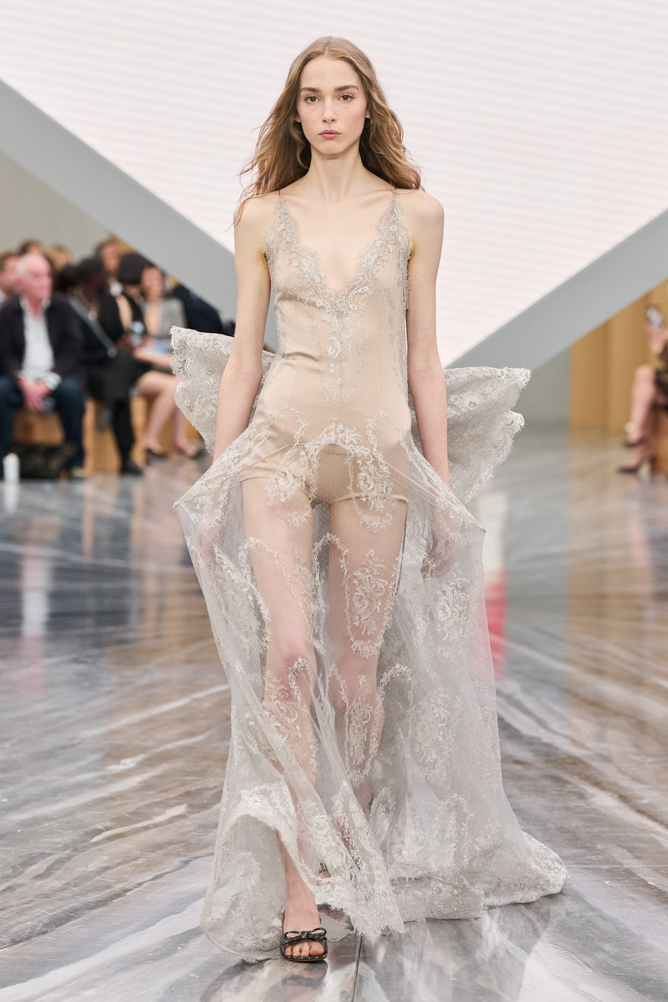 A model wears Greta Lee&#039;s sheer butterfly gown from Dior Spring 2026 on the runway