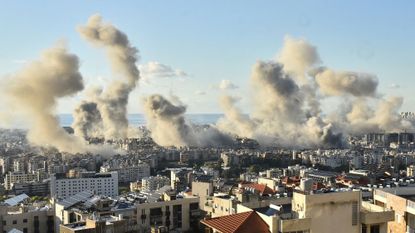 Smoke billows above Beirut's southern suburbs following an Israeli airstrike just one day before a ceasefire was announced