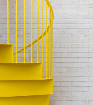 East London apartment revived by sparky yellow staircase