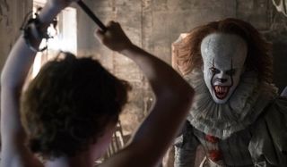 IT Sophia Lillis raises a weapon against Pennywise, baring his jaws