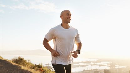 A man running outdoors looking happy