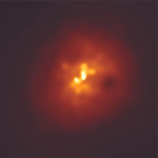 This image of the galaxy cluster Abell 2597 was spotted by NASA's Chandra X-ray observatory. In the image, you can see a cloud of hot gas with two dark "ghost cavities" resting about 100,000 light-years from its bright center. The ghost cavities are thought to be the ancient relics of an eruption from around a black hole.