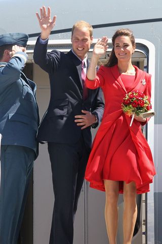 Kate and William waving at fans as they get off a plane in Canada.