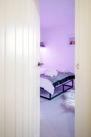 purple bedroom with white rag