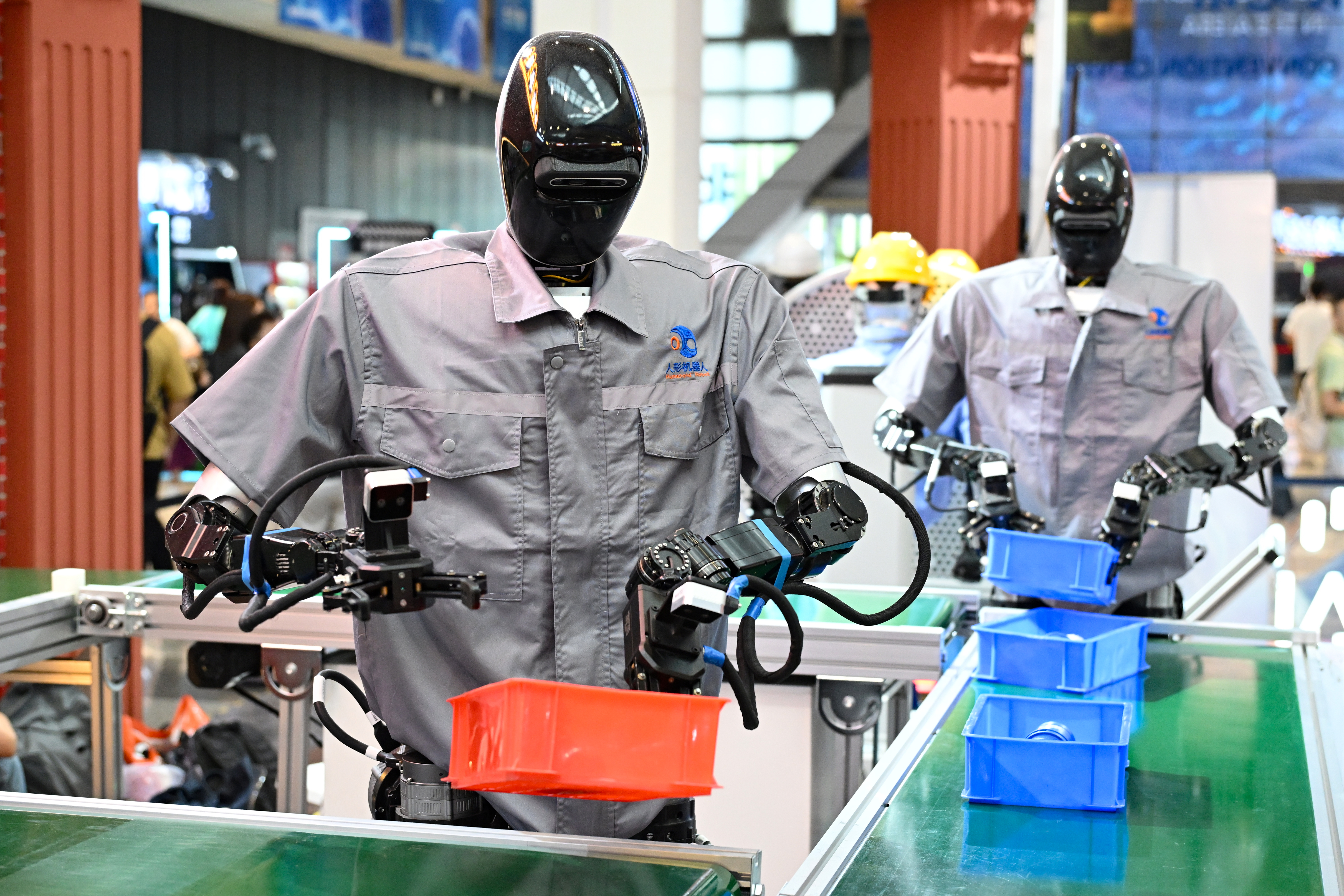 SHANGHAI, CHINA - JULY 26: Humanoid robots Qinglong sort goods at the logistics sorting line during the exhibition of 2025 World Artificial Intelligence Conference (WAIC2025) at the Shanghai World Expo Exhibition and Convention Center on July 26, 2025 in Shanghai, China. Under the theme &quot;Global Solidarity in the AI Era,&quot; the annual three-day conference, running from Saturday to Monday, has attracted over 800 Chinese and international exhibitors, showcasing more than 3,000 exhibits - a record high, including 40 large language models, 50 AI-powered devices, and 60 intelligent robots, according to the organizer. (Photo by Tian Yuhao/China News Service/VCG via Getty Images)