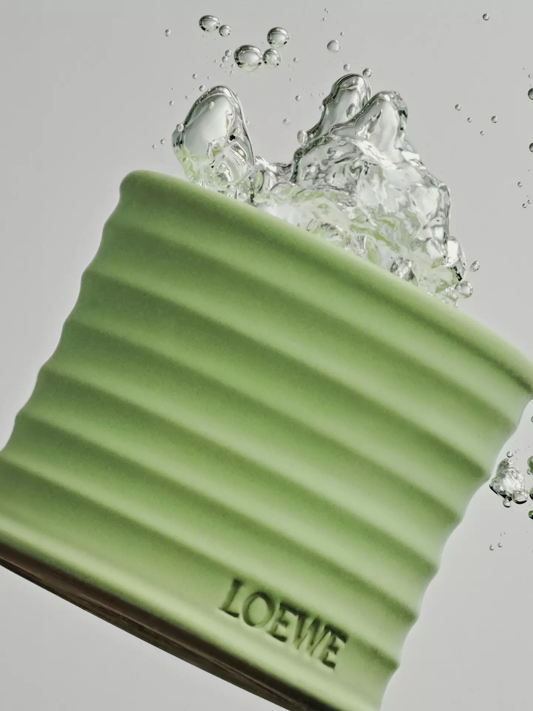 A ribbed green cucumber candle from Loewe