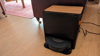 The Roomba Combo J9 Plus Base in front of a sofa