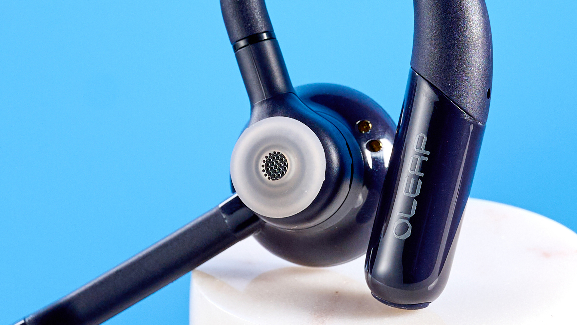 Oleap Archer AI Meeting Headset photographed in front of a blue background.