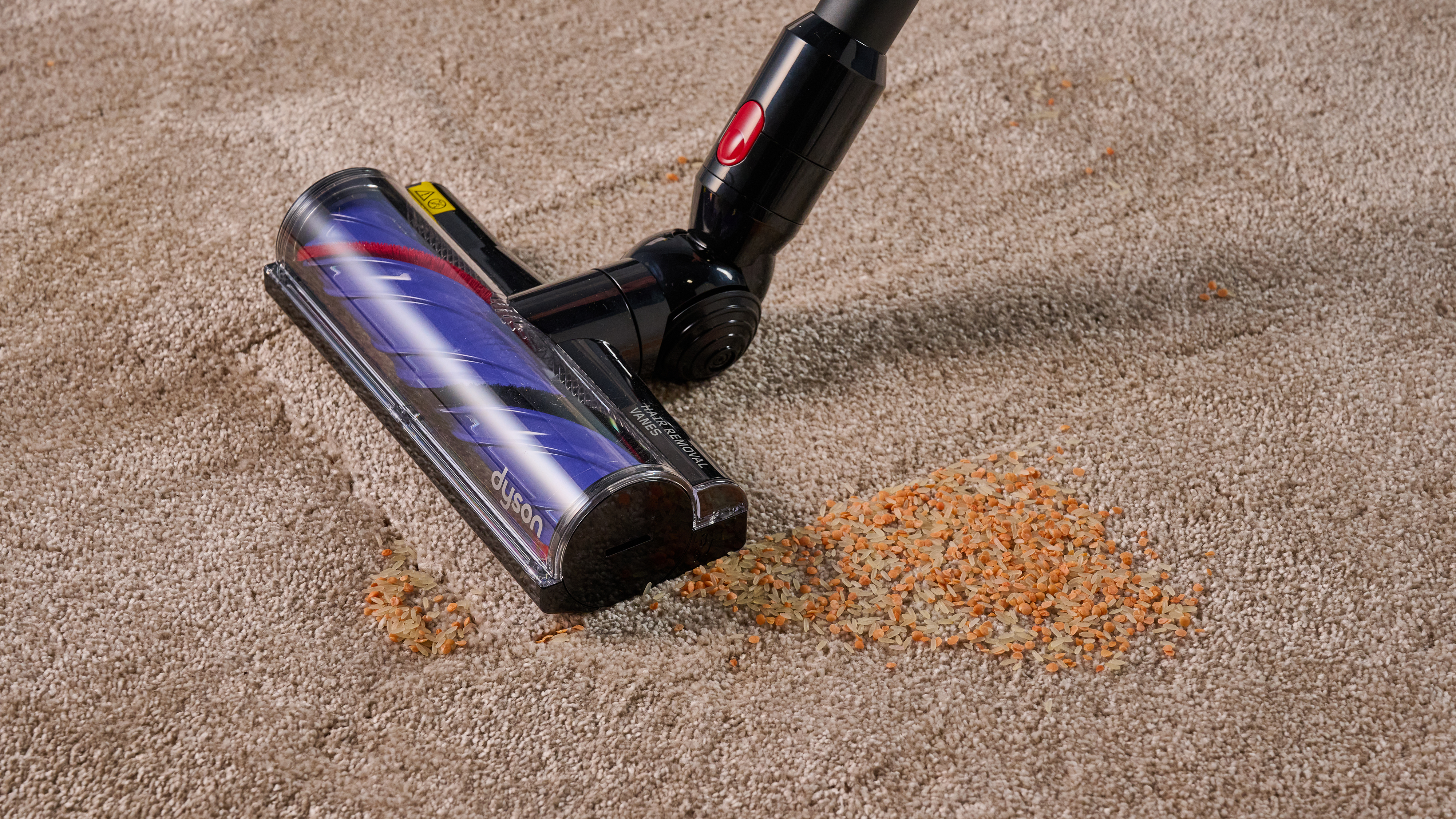 Dyson V8 Cyclone vacuum cleaning rice and lentils from carpet