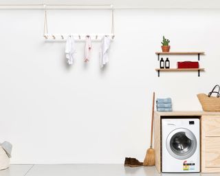 hanging drying rack in a laundry room with washing machine from George and Willy