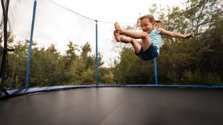 Child jumping on a trampoline.