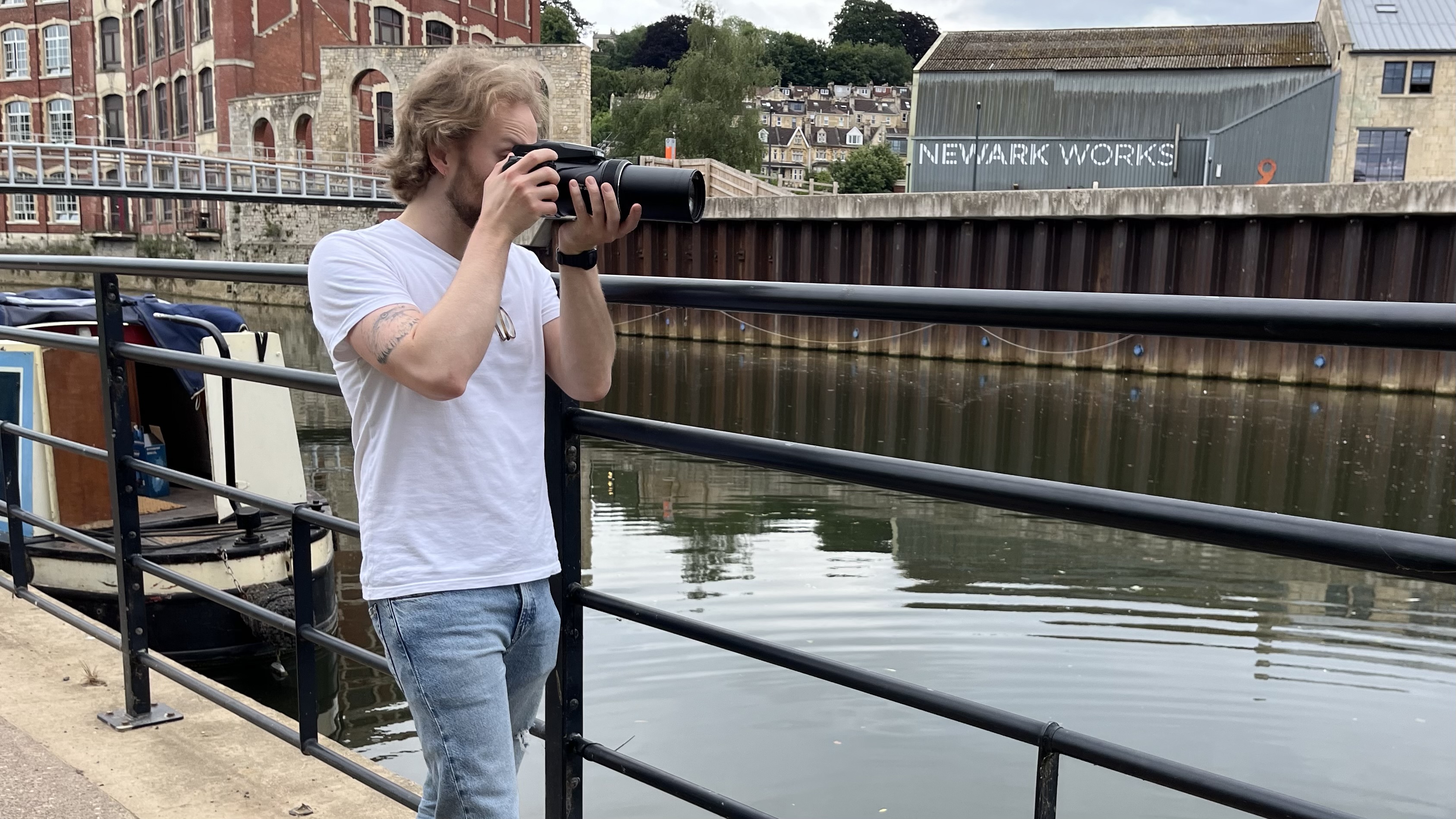 Nikon Coolpix P1100 lifestyle image of Mike Harris holding camera by river