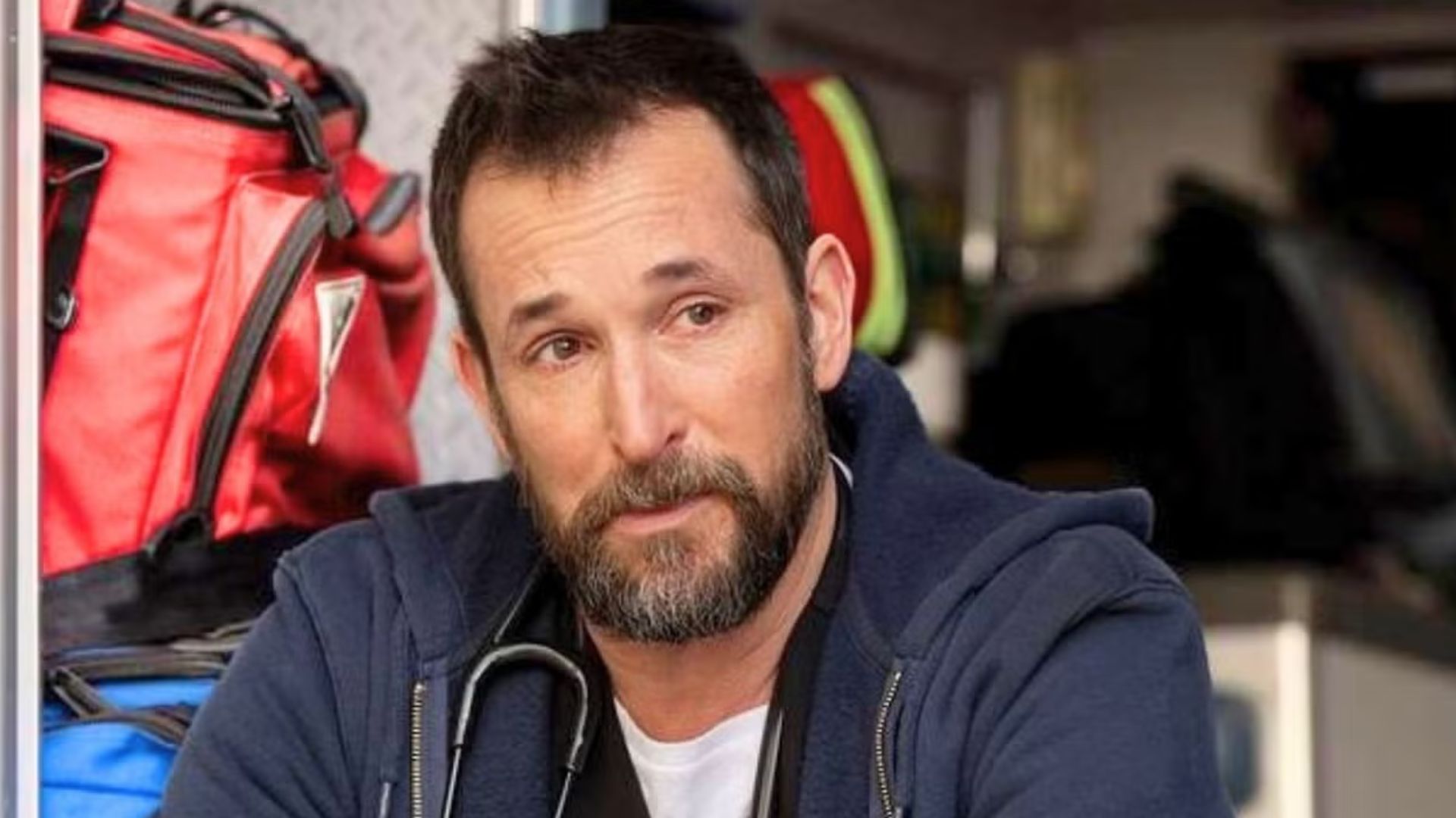 Dr Robby cries sitting in the back of an ambulance