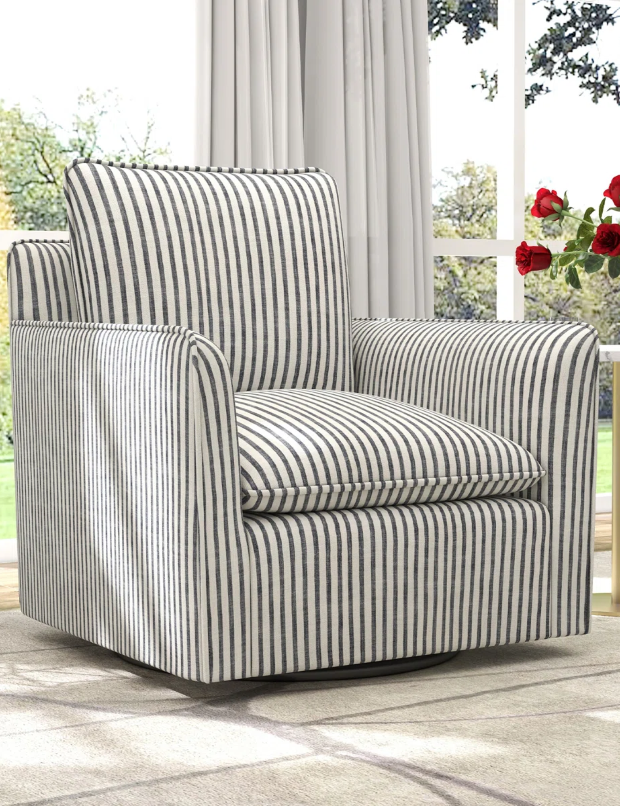 Nancy Meyers-style striped swivel chair pictured in a sitting room featuring large window panes and a modern side table