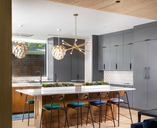 grey kitchen with wood kitchen island by Maestri Studio