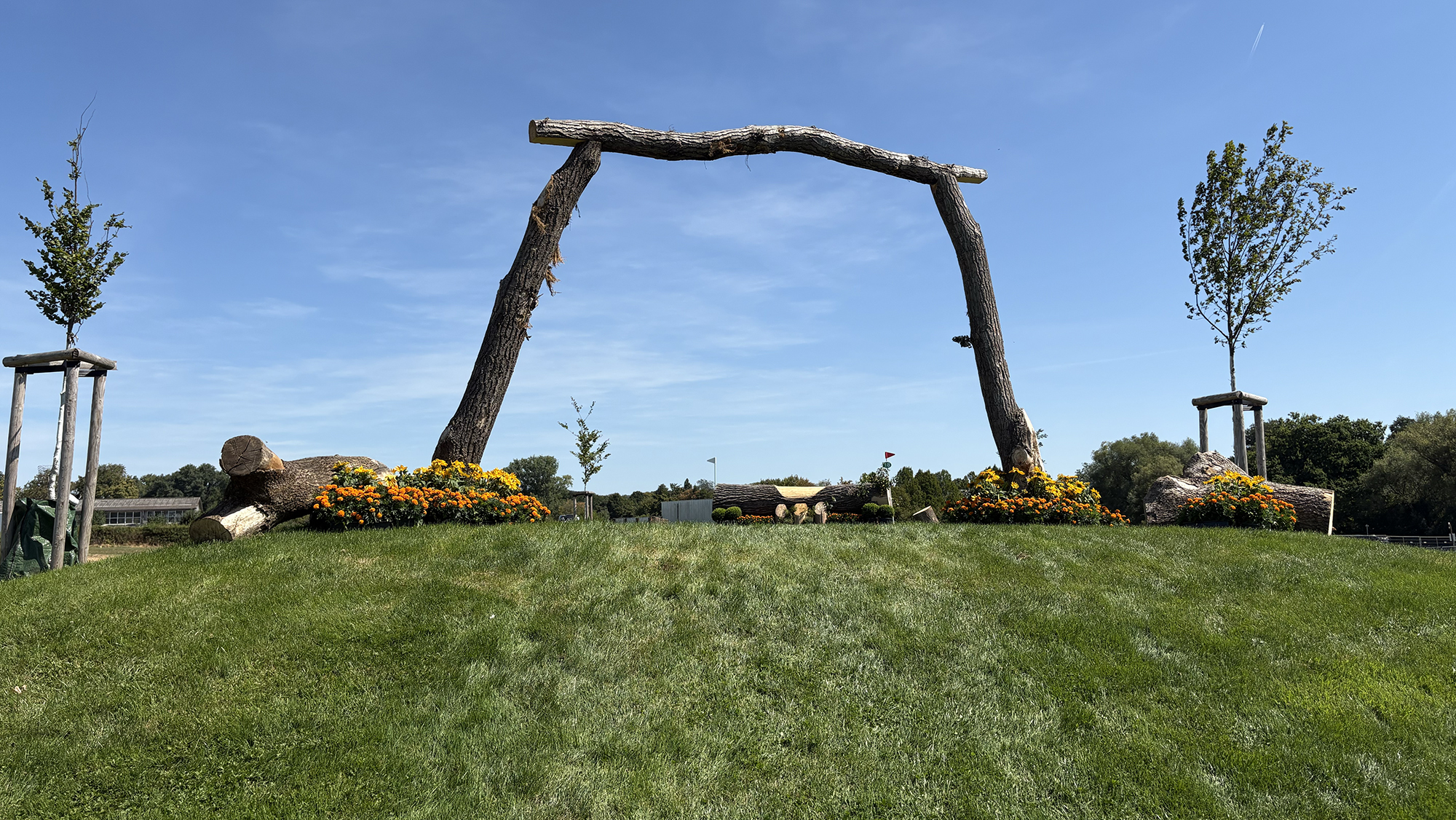 Approach to a fence under an arch and up a mound on the eventing World Championships cross-country course