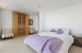 Bedroom with white wall and chairs