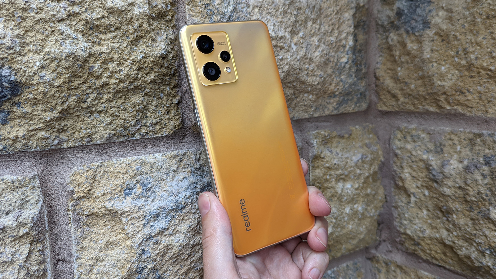 The back of the Realme 9 being held up against a wall