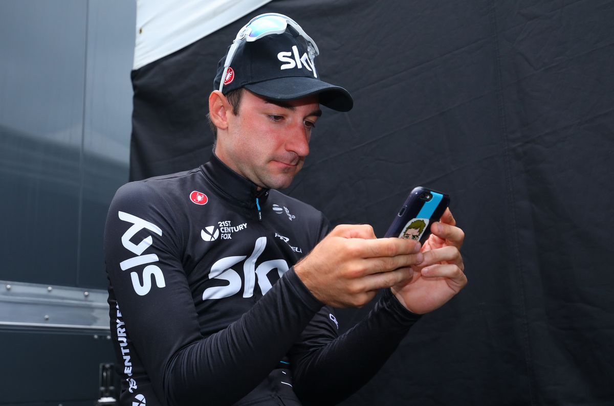 Elia Viviani checking his phone after the stage