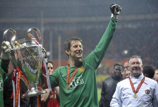 Edwin van der Sar celebrates Manchester United's 2008 Champions League final win over Chelsea alongside manager Sir Alex Ferguson.