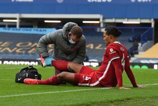 Liverpool defender Virgil van Dijk receives treatment after colliding with Everton goalkeeper Jordan Pickford and suffering a serious injury at Goodison Park in October 2020.