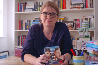 A portrait of Cathy Rentzenbrink against a backdrop of books