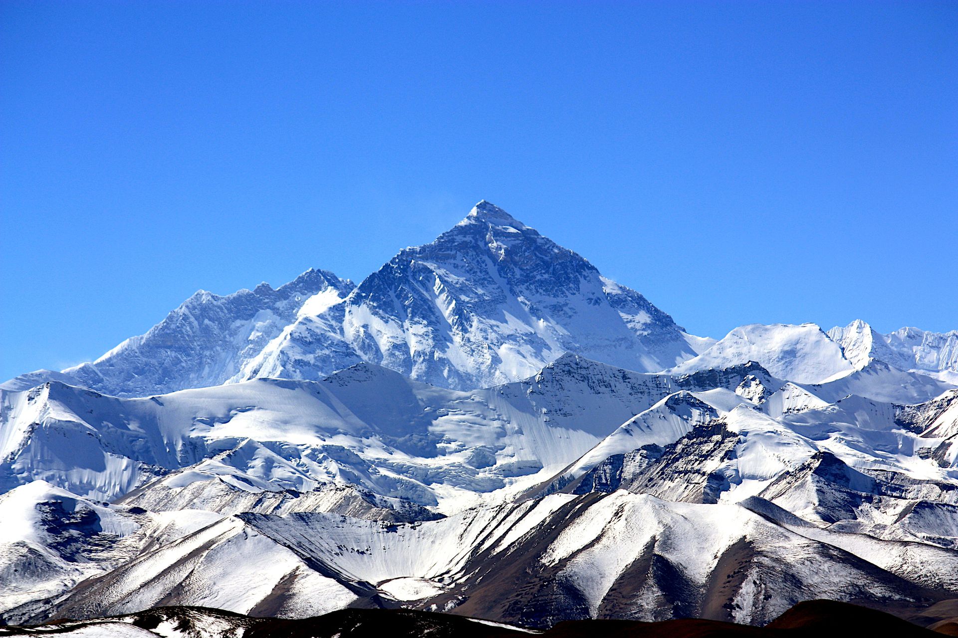 Mount Everest rising in the distance amid foothills.