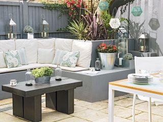 outdoor seating ideas: grey seating with wall